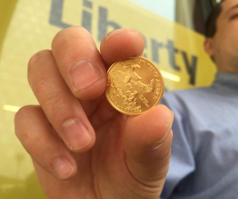 Me holding a gold coin purchased from Amzaon